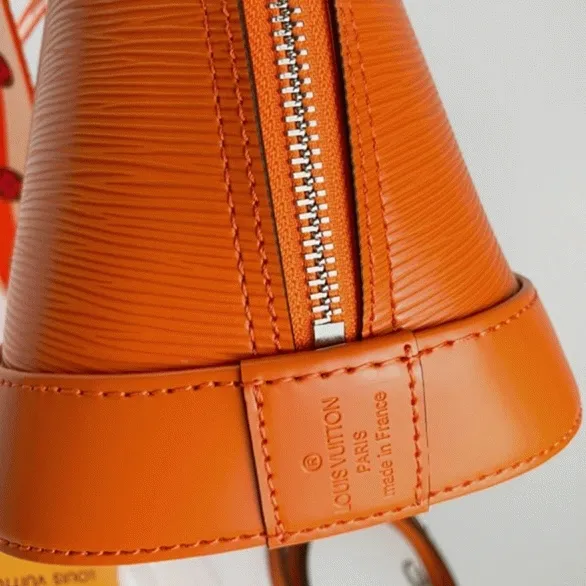 Louis Vuitton Epi Leather Alma PM Handbag In Orange With Jacquard Strap — image 9